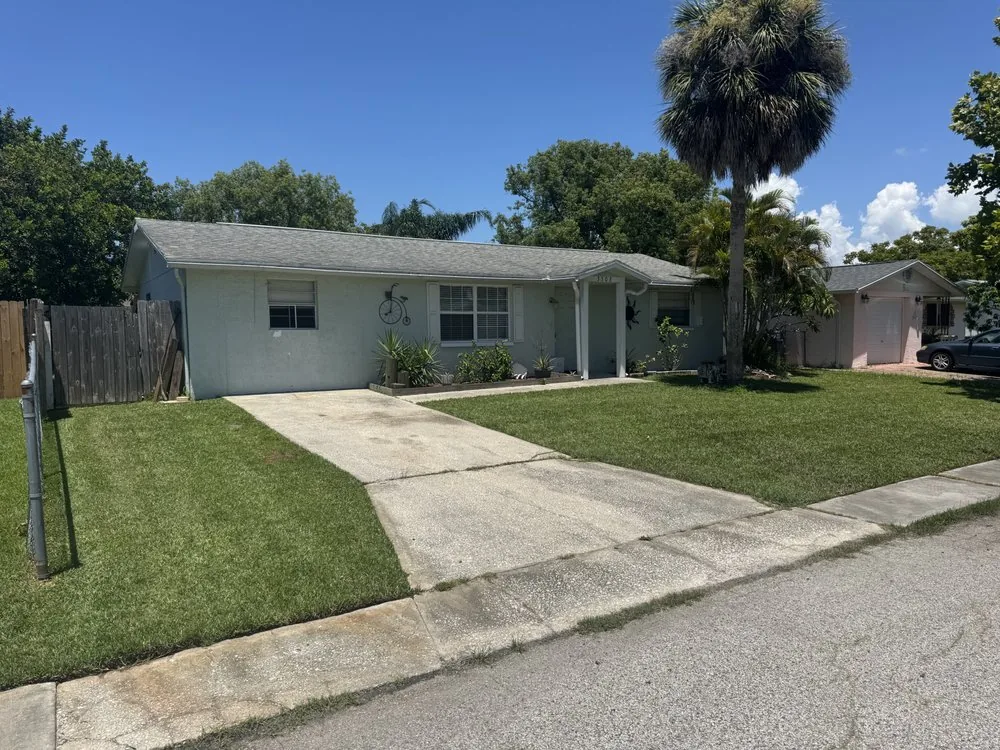Clean edged lawn along a driveway and walkway