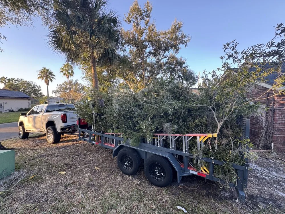 Truck and trailer loaded with yard debris for hauling
