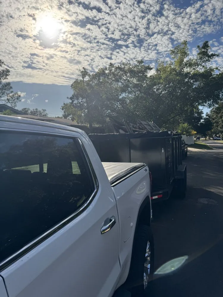 LawnSmith truck with dump trailer ready for a hauling job