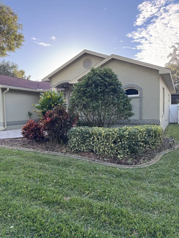 Landscaped flower beds with fresh mulch and trimmed shrubs
